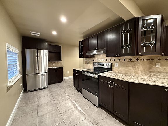 Sprawling kitchen with granite countertops and stainless steel appliances