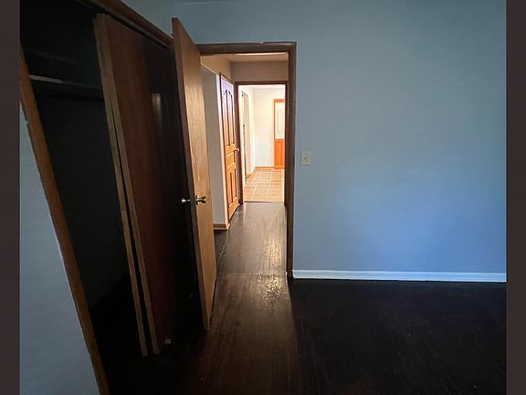3rd bedroom (upstairs) looking down hall into kitchen