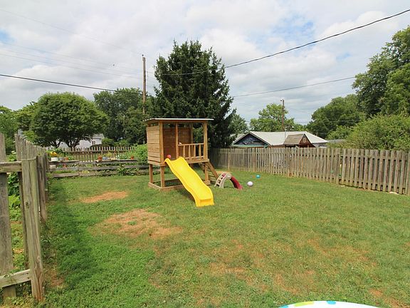 yard with garden and playhouse 