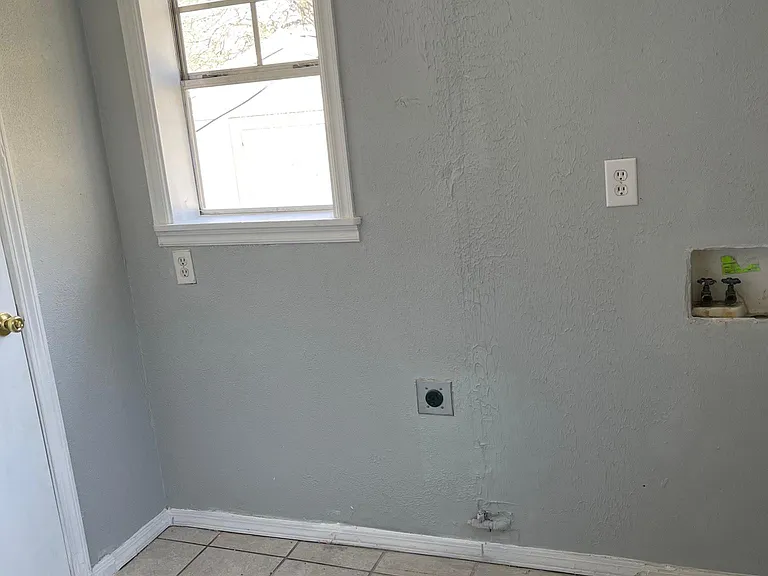 Laundry room beside kitchen