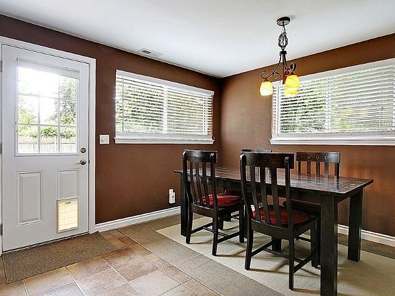 Formal dining room adjacent to kitchen and family/bonus room opens to lovely yard/patios.