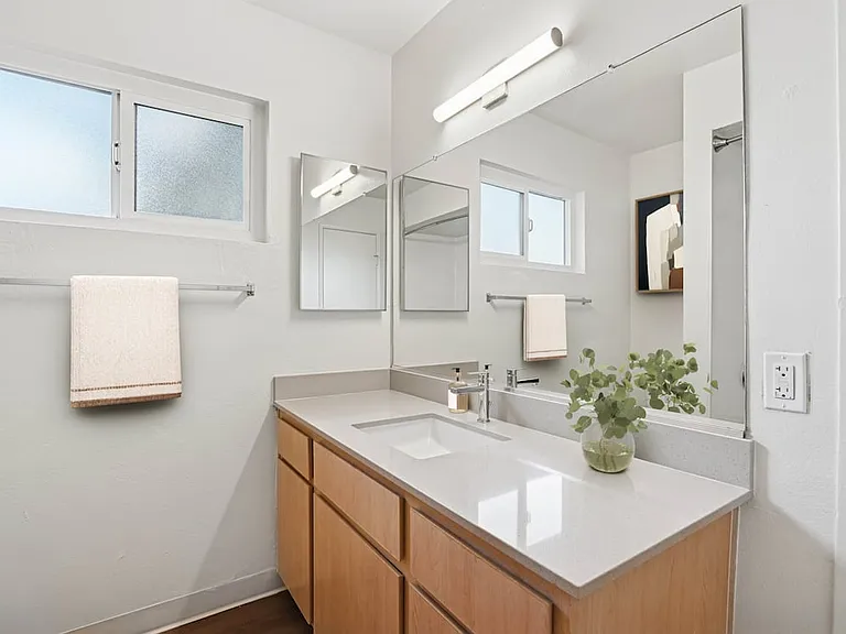 Classic Package II bath with beige quartz countertop, oak cabinetry, and hard surface flooring