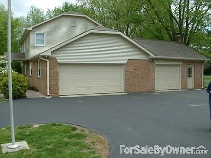 West end of home
						:
						Large asphalt parking area.
