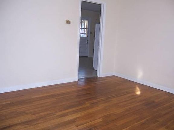 Large living room with hardwood flooring & big window!