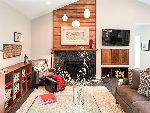 Open Living room with wood burning fireplace