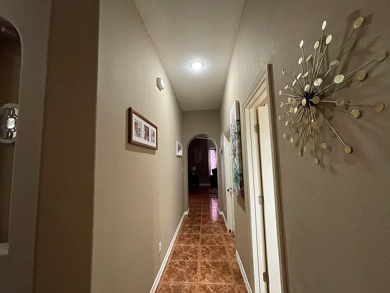Two bedrooms and a full bathroom are conveniently located off this hallway