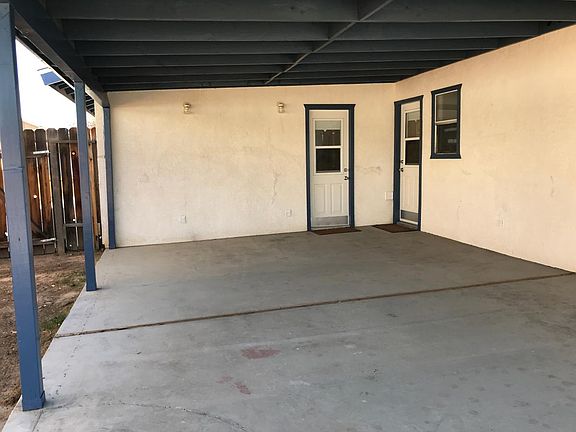 Rear covered patio. Access via kitchen and garage doors.