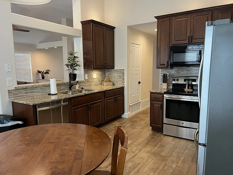 Spacious kitchen layout with recessed lighting and open access to the main living area.