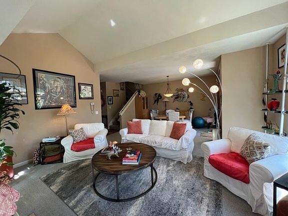 Living Room has Cathedral Ceilings, Fireplace, abundant natural light, access to back private patio.