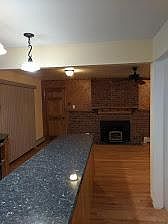 Kitchen to family room, wood burning fireplace insert, hardwood floor, sliding glass door