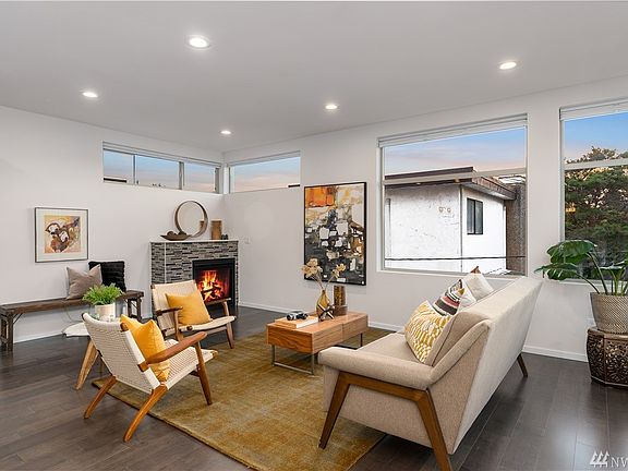 Light, bright, and large family room with fireplace and wood floors