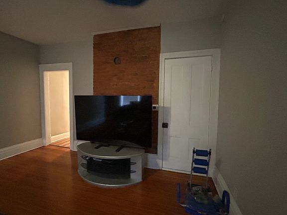 Living Room with Closet and original Brick Chimney Wall