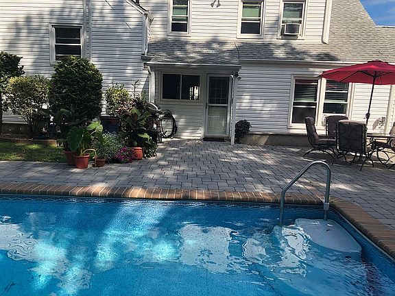 Back of home with the pool