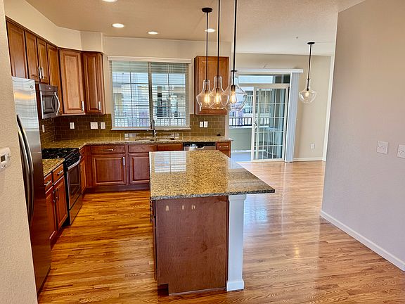 View toward kitchen, dining area, and rear outdoor patio.