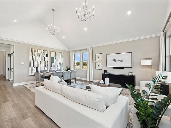 Great room with vaulted ceiling and dual chandeliers