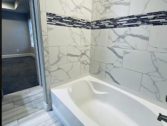 Master garden tub with porcelain tub surround