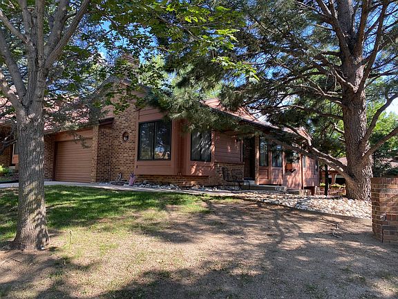 Looking southeast at the property. Front door entrance on west side.