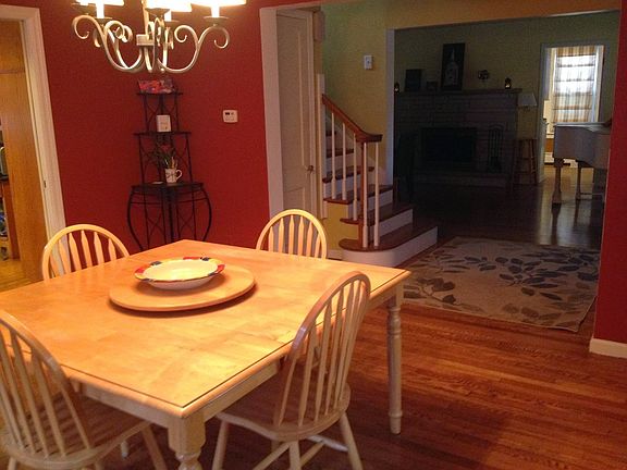 Formal dining room looking into entry foyer, stairs to 2nd f