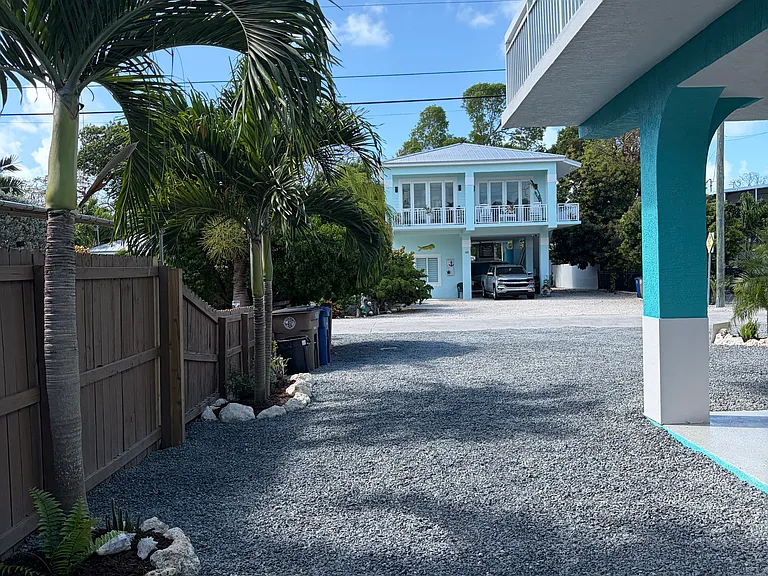 Your Parking area on the right side of carport in front of house between the palm tree and the house pillar