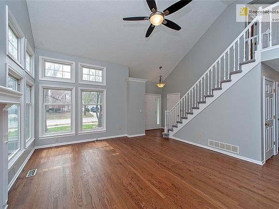 Sunny Vaulted Great Room w/Ceiling Fan, Refinished Hardwood Floors, Fireplace, & New Paint! Windows Galore!