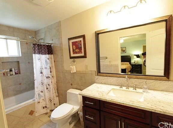 Master bathroom with granite counter top, vanity cabinet and linen cabinet cherry wood color