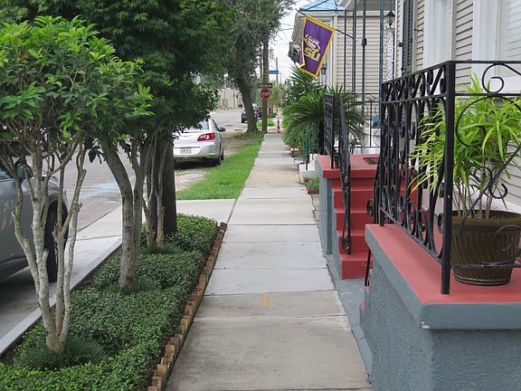 Landscaped front yard with newly built street, sidewalks, curb and driveways