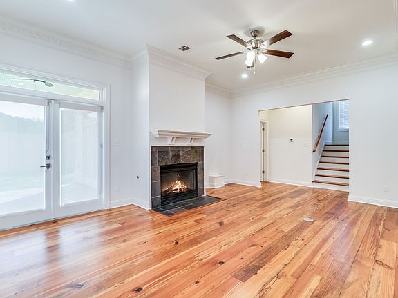 Living room features refinished wood floors, a gas fireplace, and lots of natural lighting.