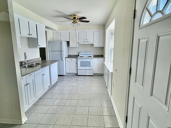 Full kitchen with electric stove, dishwasher, refrigerator, microwave, and bay window seating