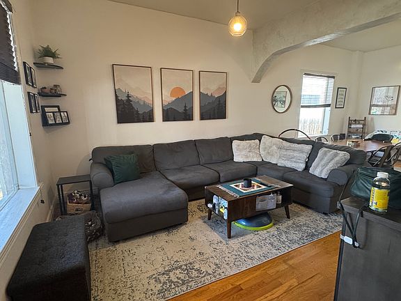 Open plan living room with large windows