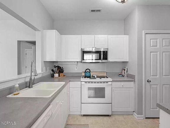 full kitchen including refridgerator, dishwasher, oven, microwave and pantry
