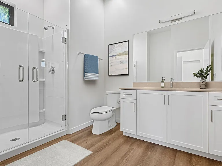 Freestanding Home bath with beige quartz countertop, white cabinetry, and hard-surface flooring