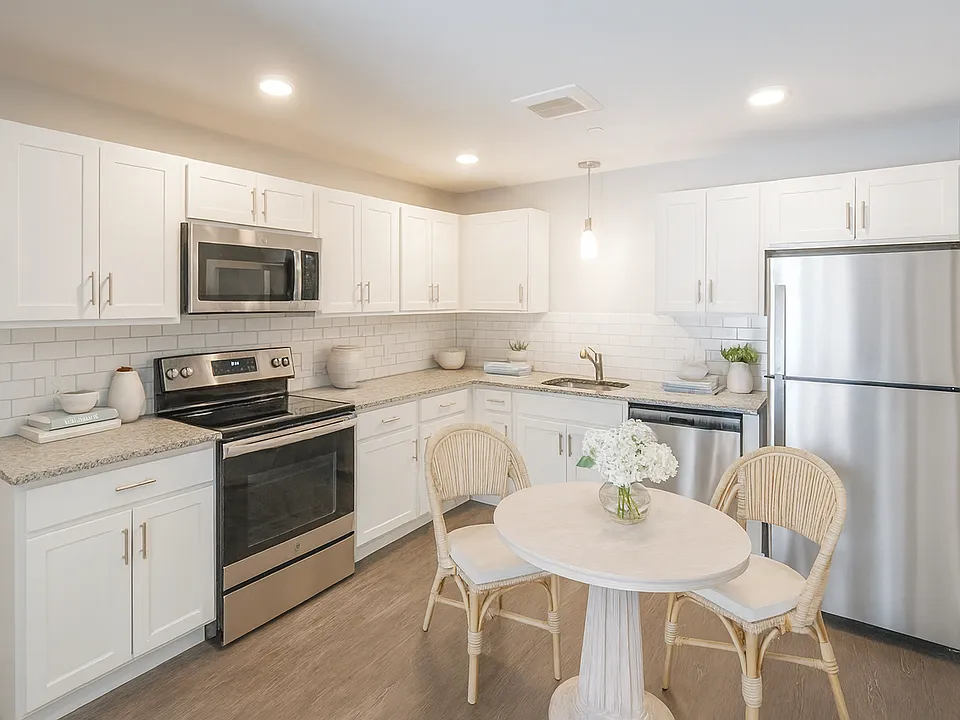 White kitchen cabinets, granite countertops and stainless steel appliances.