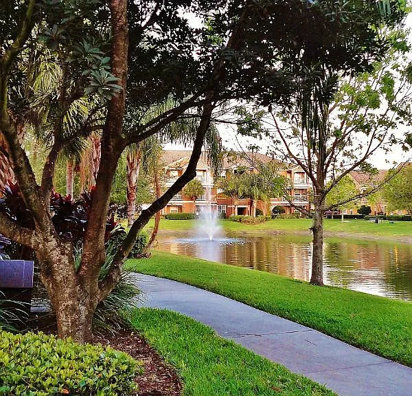 Peaceful walkway around pond with fountain at Mirabella