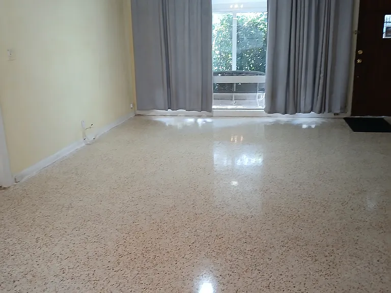 I just had the tile removed and the original terrazzo floors restored and buffed to a gloss shine.