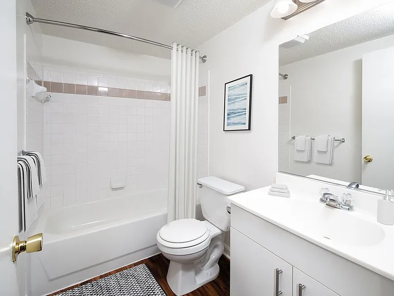 Classic Package I Bath with white cabinetry, white laminate countertops, and hard surface flooring