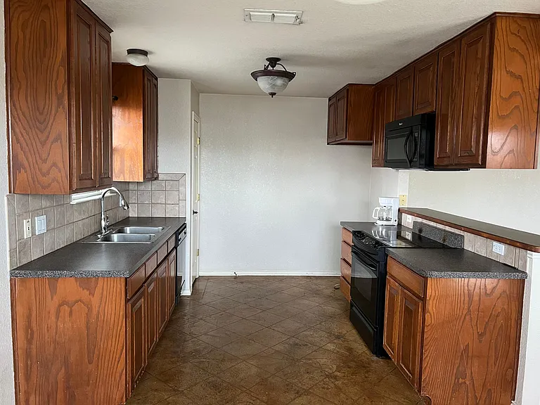 Kitchen with new faucet, microwave, stove/oven range, and disposal. and Pantry