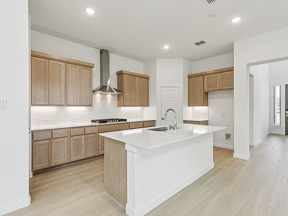 Kitchen in the Da Vinci II home plan by Trophy Signature Homes - REPRESENTATIVE PHOTO