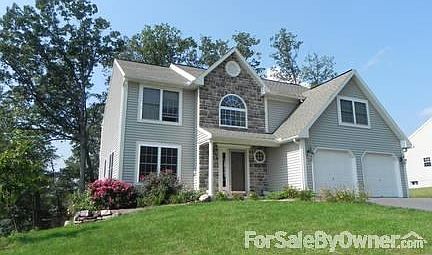 Front of home in Summer.
						:
						Home faces to the East.