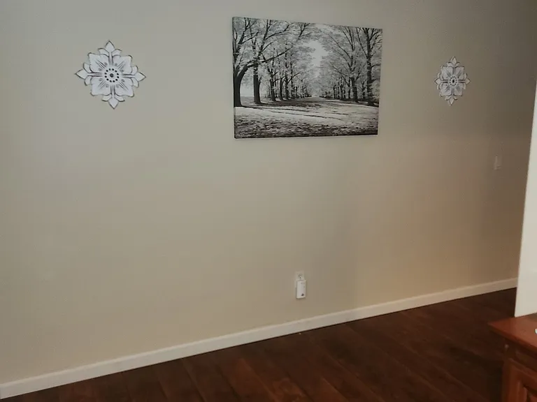 Hallway with built in cabinets & laundry room. Bedrooms on opposite sides.