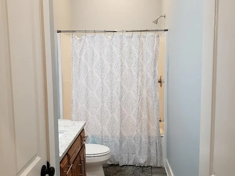 Full bath off living room; 36" vanity, bath/shower, linen closet