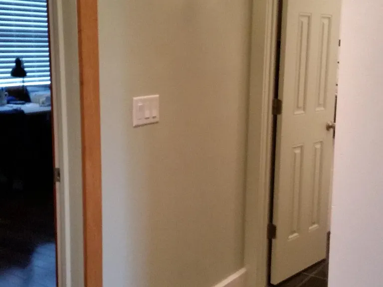 entrance to bathroom, pantry on the right
