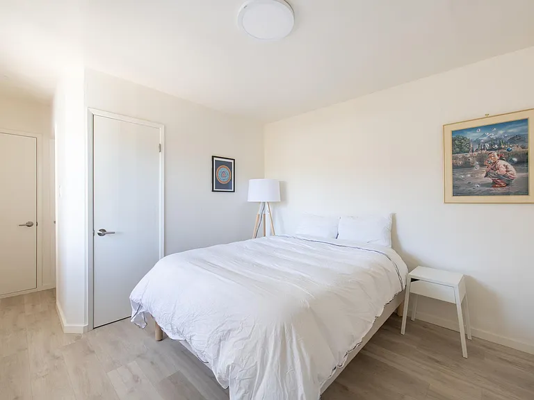 A bedroom that comfortably fits a Queen bed. Plenty of closet space
