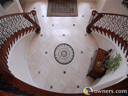 Entry view from upstairs shows travertine floors