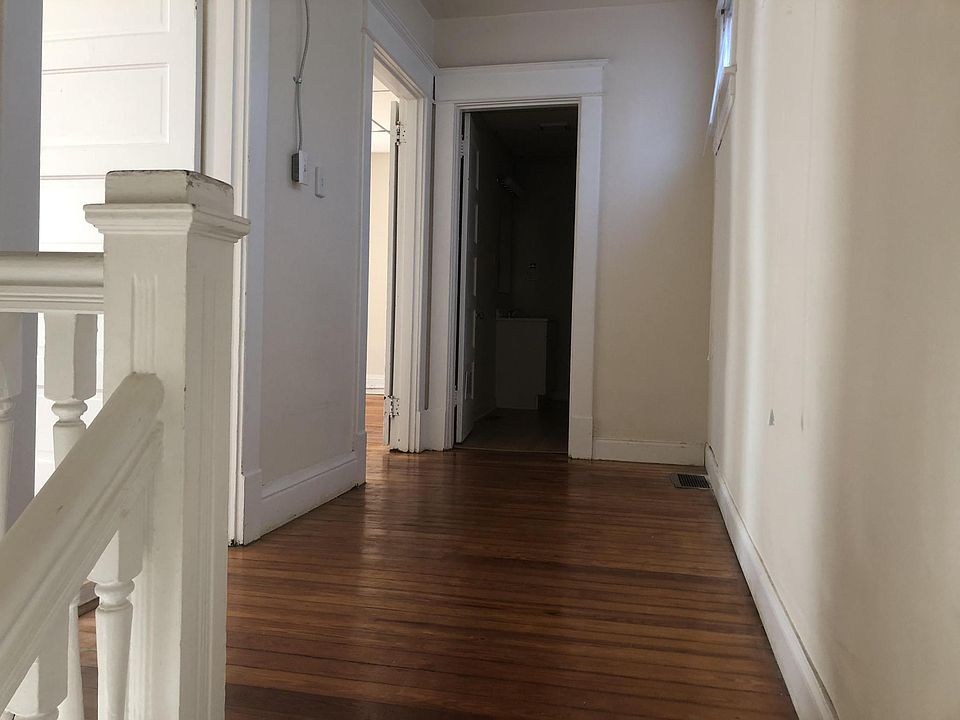 Large open upstairs hallway with beautiful hardwood floors
