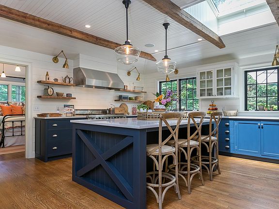 HUGE chef's kitchen is an entertainer's DREAM! This kitchen features a 48" professional-grade Viking 6-burner stove with stove-top grill and 2 ovens, a Sub-Zero fridge, 2 Bosch dishwashers, 2 porcelain farmhouse sinks and 4 under-counter garbage and recy