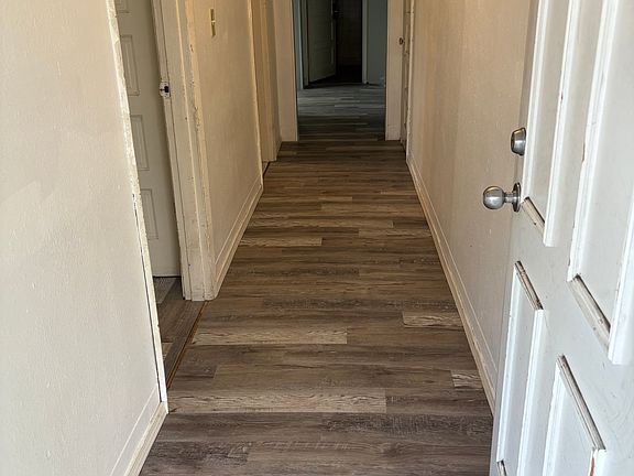 Entry front door and interior hallway of apartment