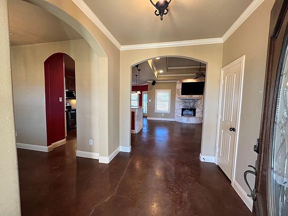 Step inside this fabulous home and you'll immediately notice the large, open floor plan. The stained concrete flooring is easy to maintain, and the crown molding and rounded corners add a touch of elegance.