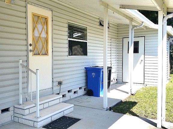 ENTRANCE BEHIND CARPORT.