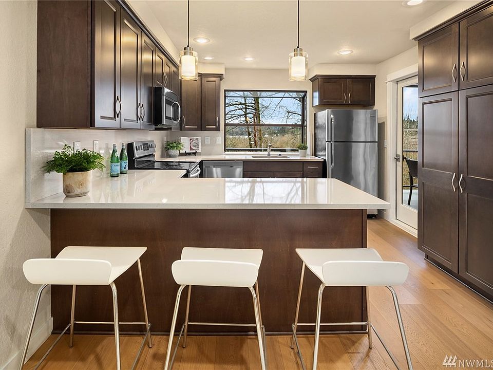 Beautiful remodeled kitchen cabinetry with quartz counters and stainless steel appliances. 