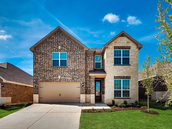 This 4-bedroom, 2.5-bath home has a gorgeous brick and stone exterior with a fully landscaped front